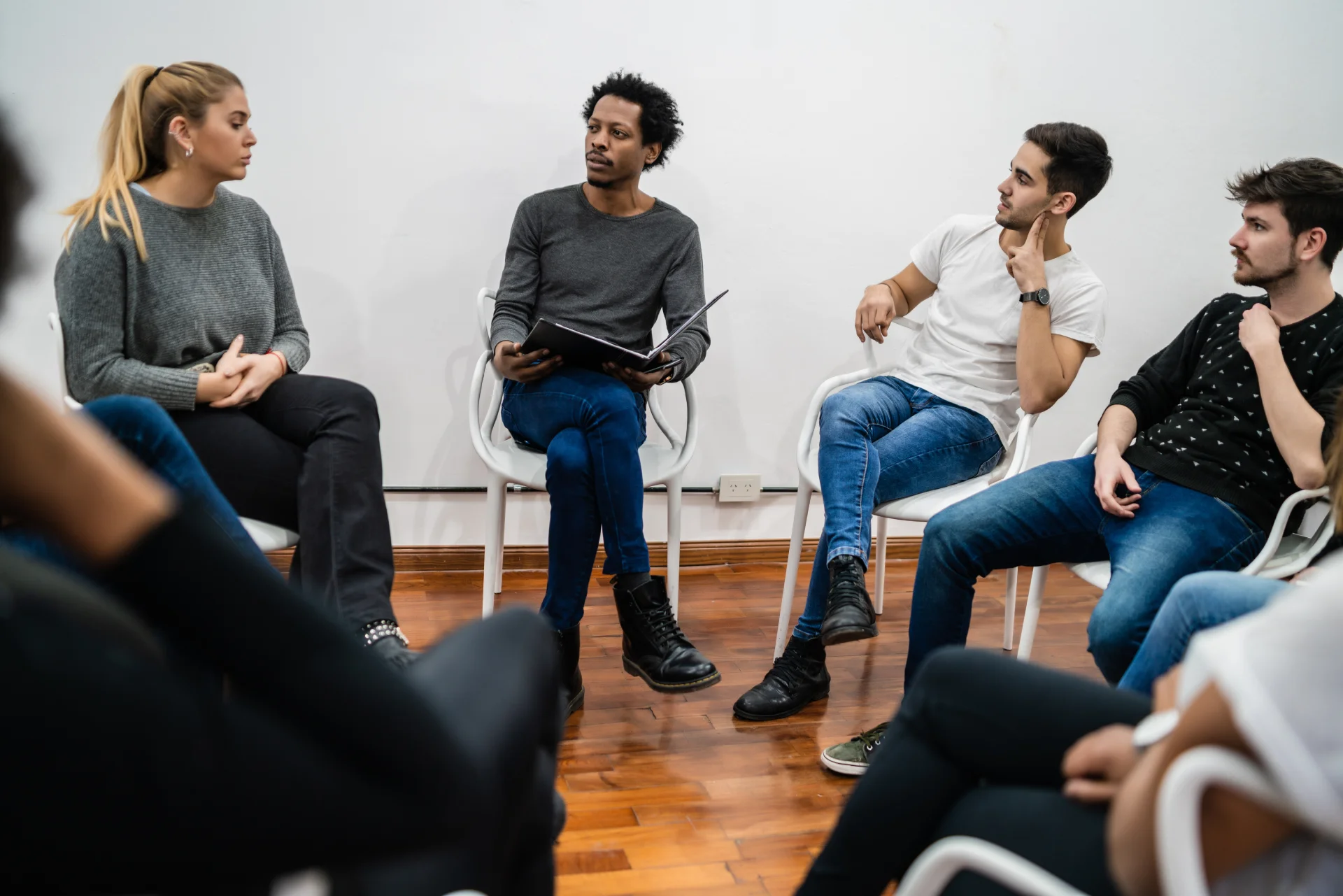 A supportive group therapy session in Long Island, with participants seated in a circle, symbolizing unity and encouragement.