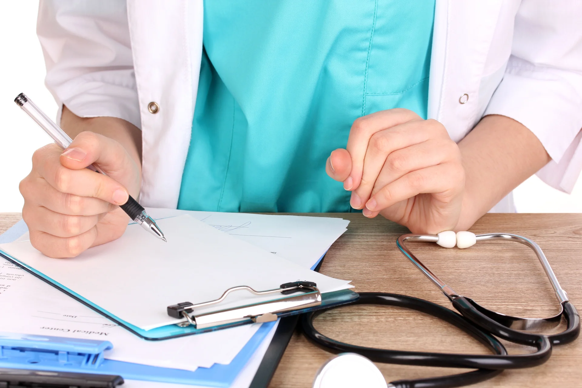 Doctor writing down the follow-up plan in his notes