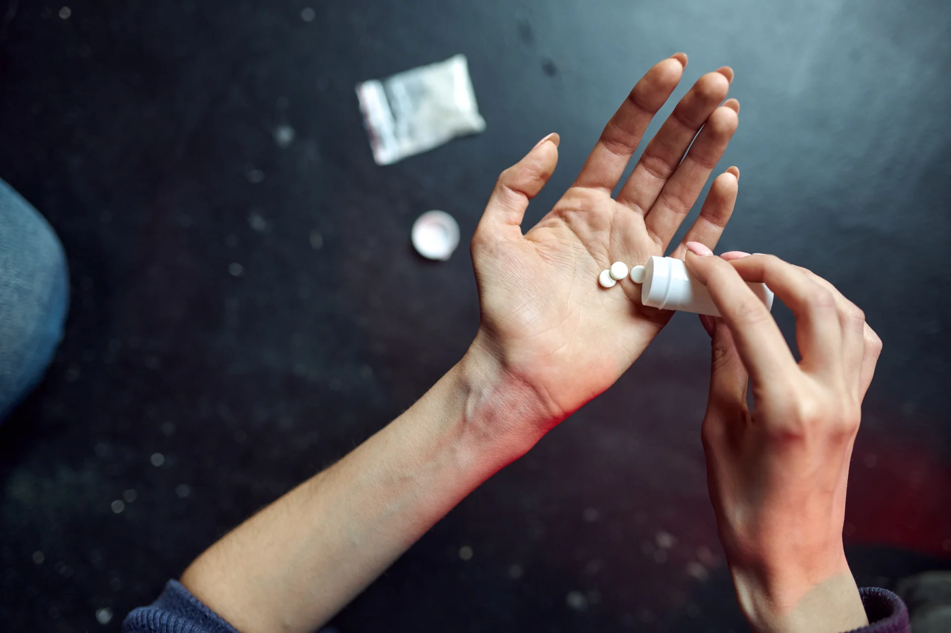 person holding pills 