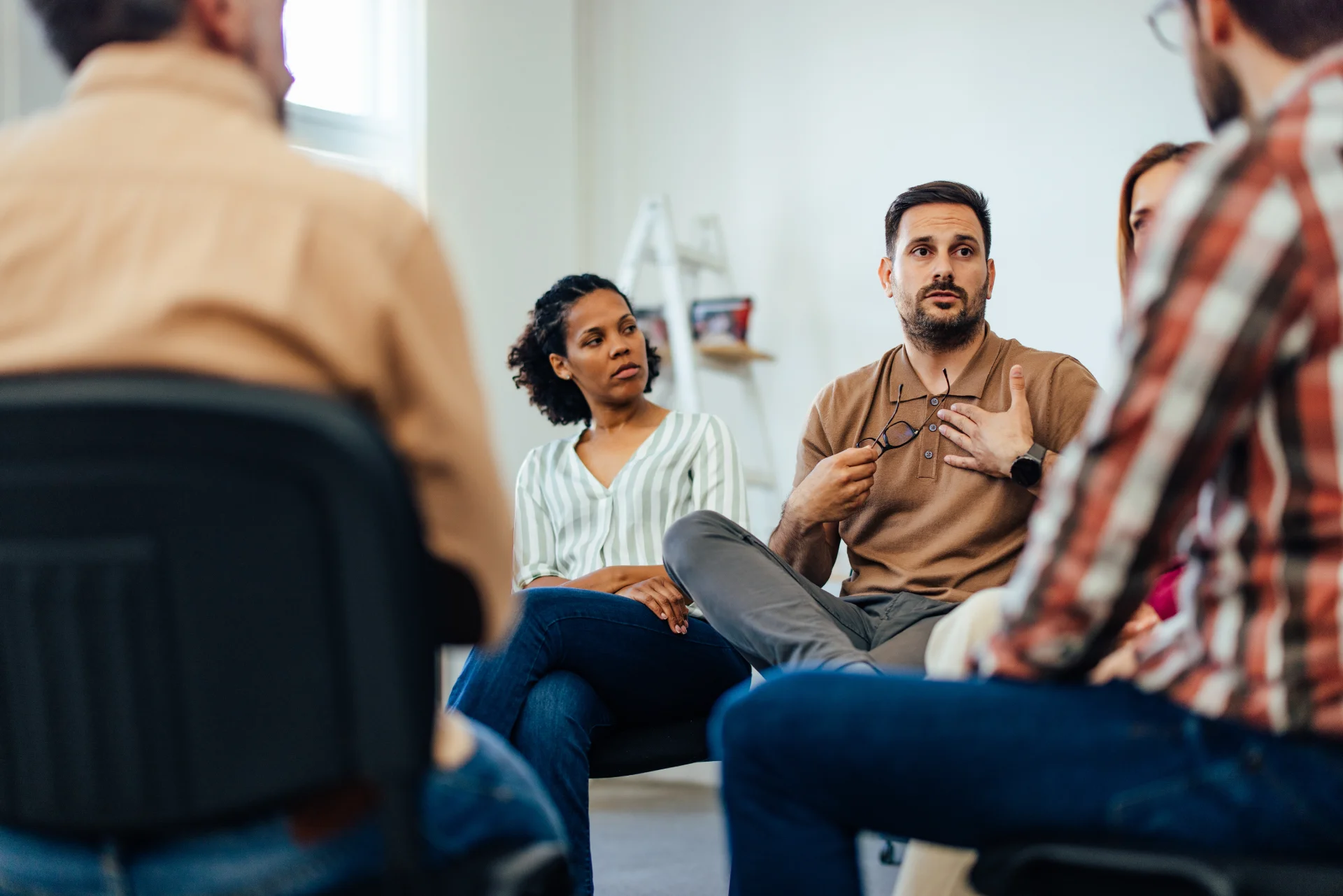 A recovery support group sitting in a circle