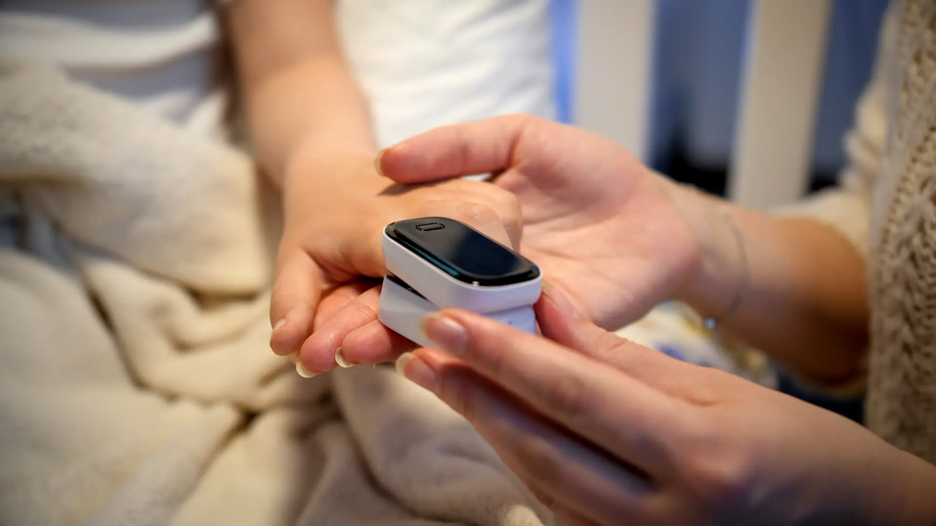 Woman putting pulse oxymeter on finger